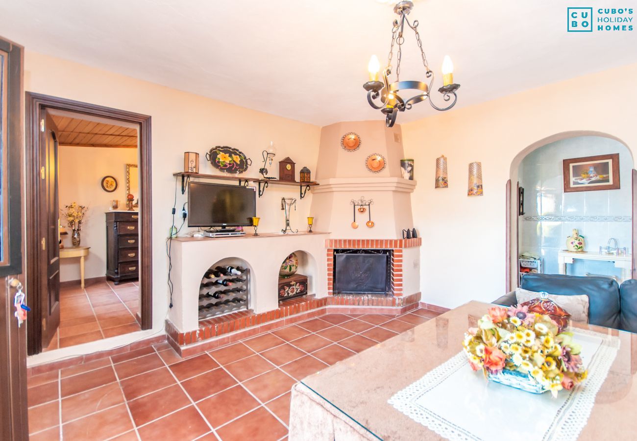 Salón comedor con chimenea de esta finca en Alhaurín el Grande