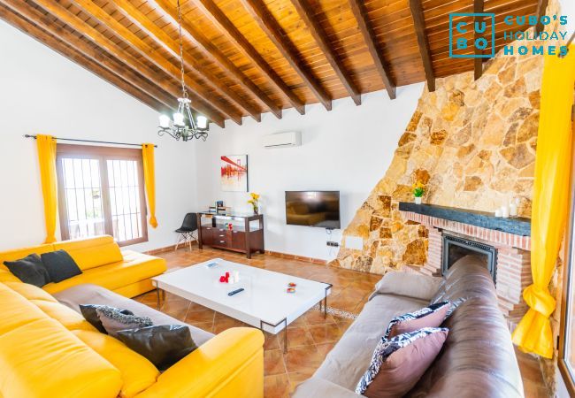 Living room with fireplace in this villa in Alhaurín el Grande