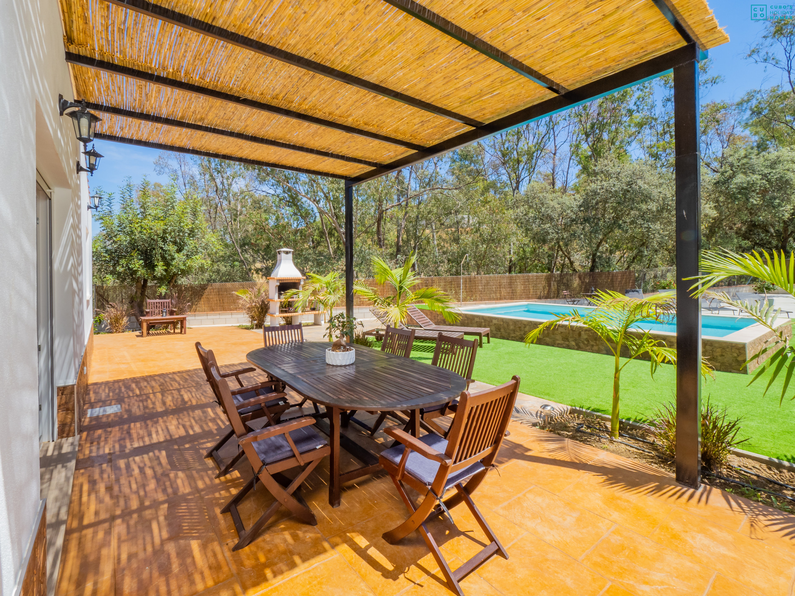 Exterior porch of the accommodation with views of the pool.