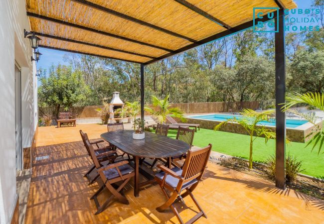 Exterior porch of the accommodation with views of the pool.