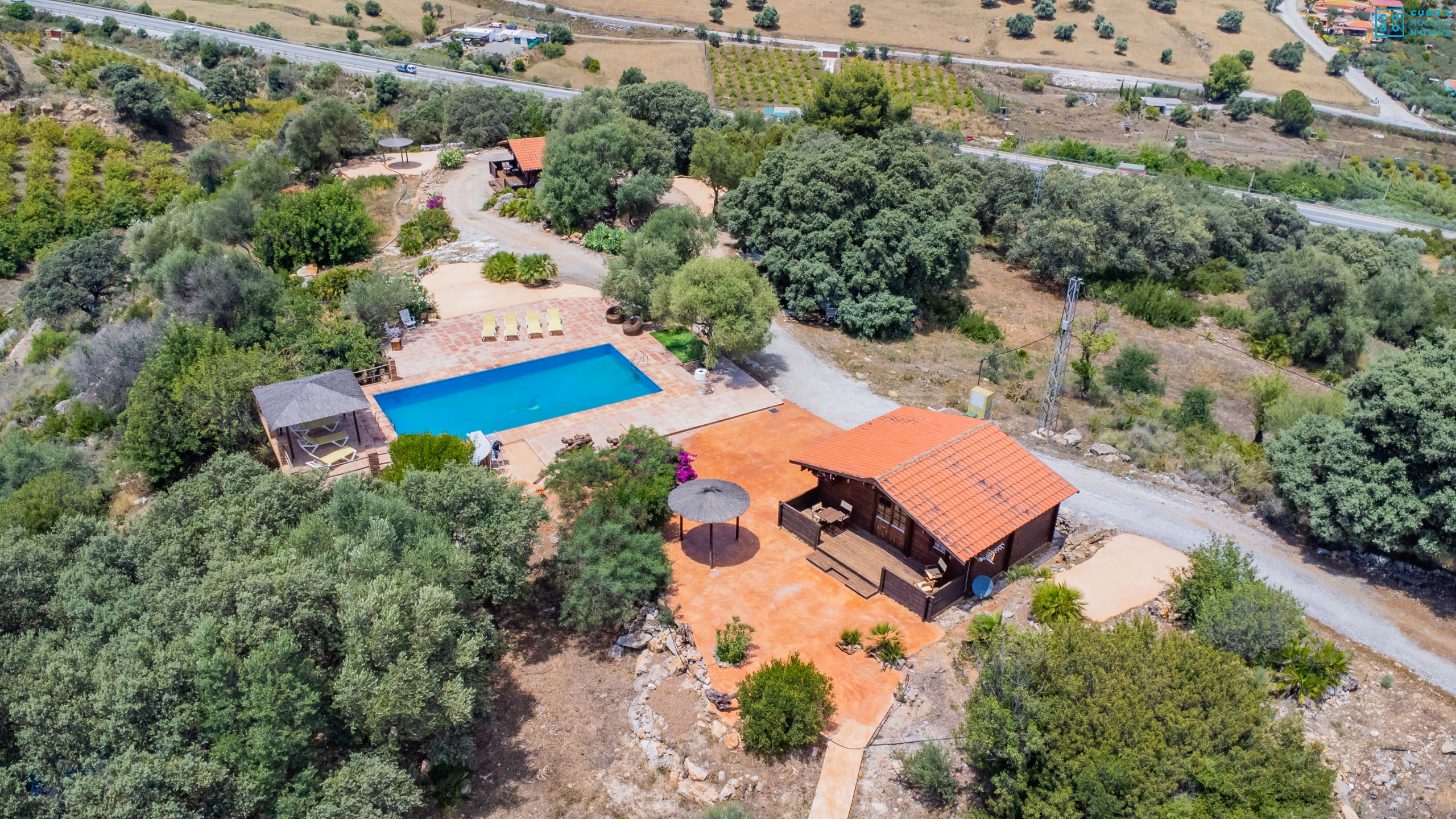 Swimming pool of the accommodation and its natural surroundings of the charming log cabin.  