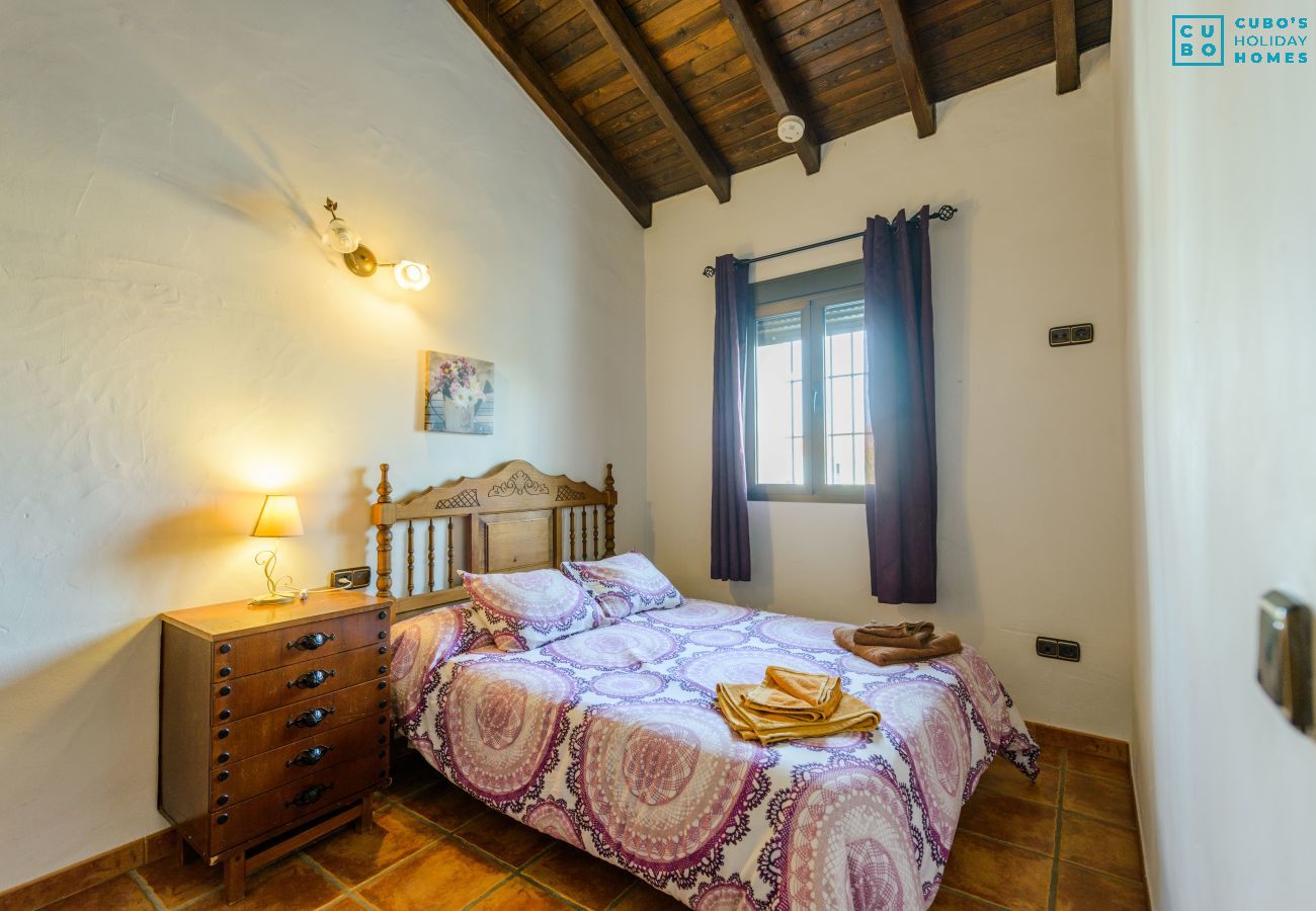 Bedroom of this house with fireplace in Alhaurín el Grande