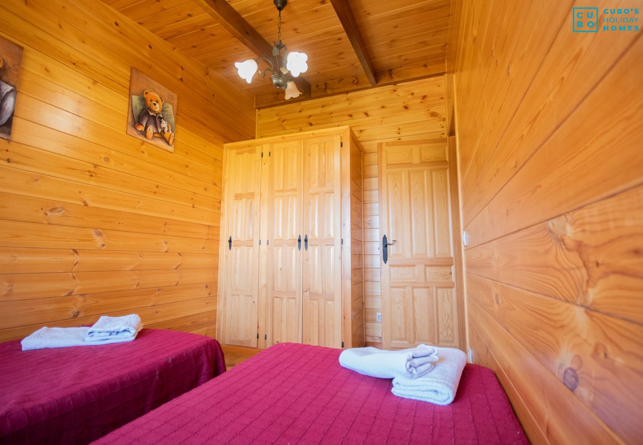 Bedroom of this wooden house in Alhaurín el Grande