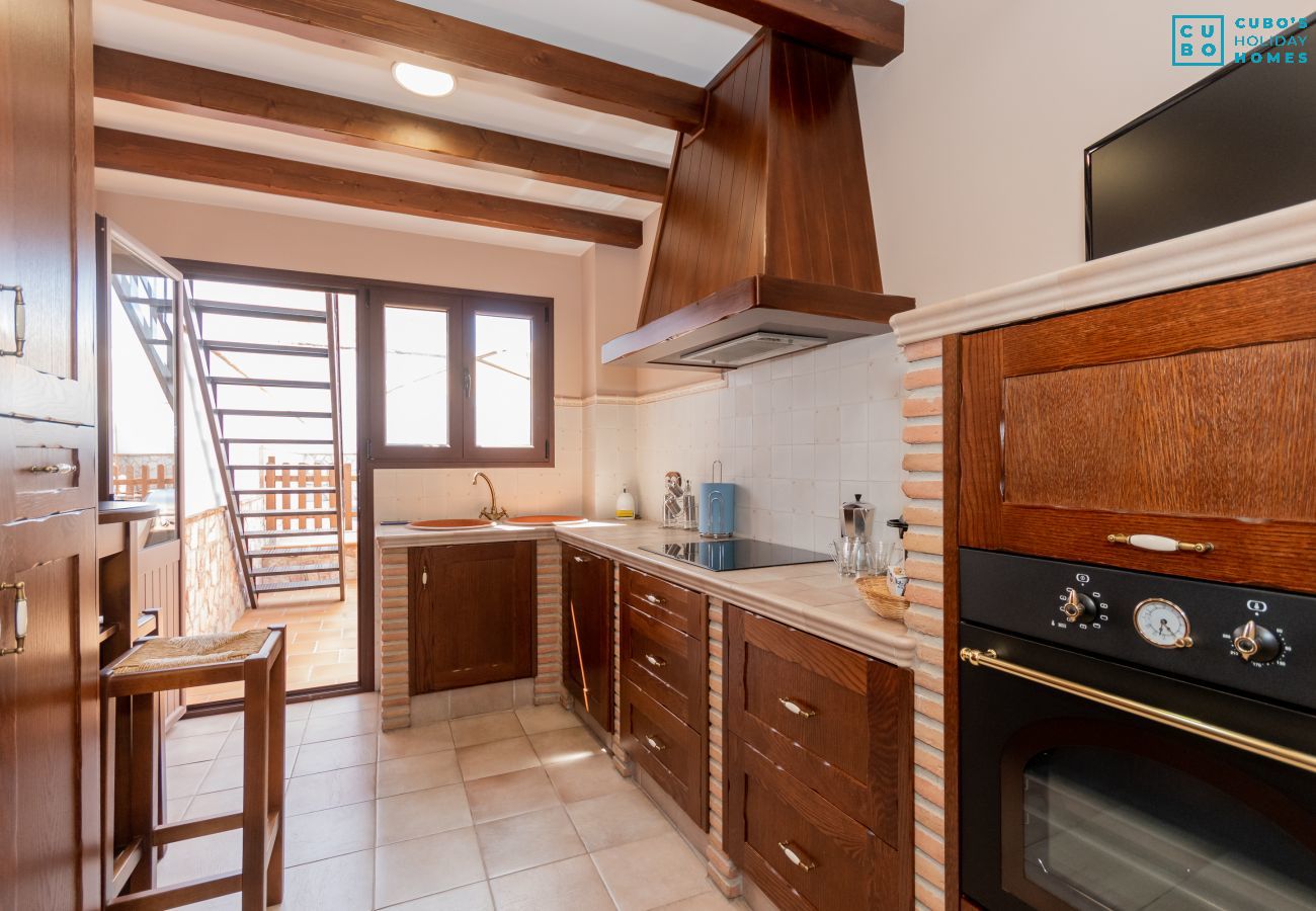 Kitchen of this house with fireplace in El Torcal