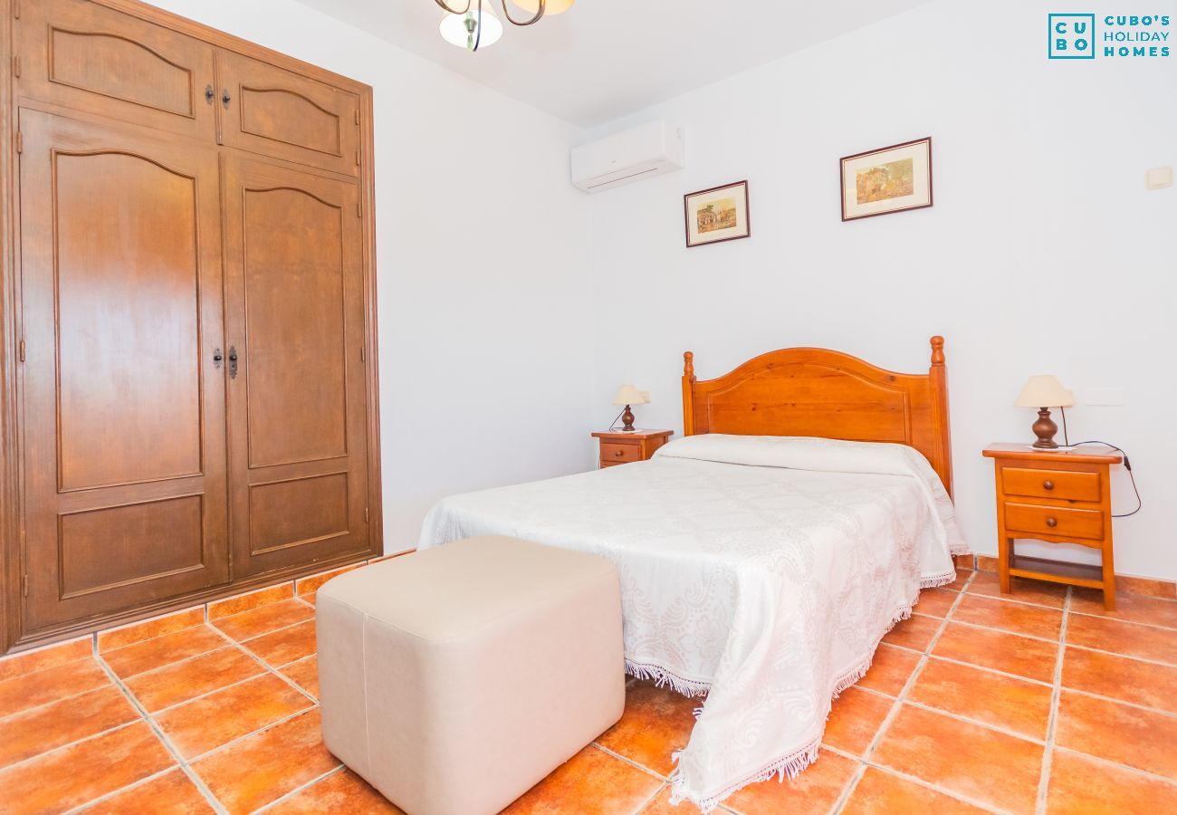 Bedroom of this house with fireplace in Coín