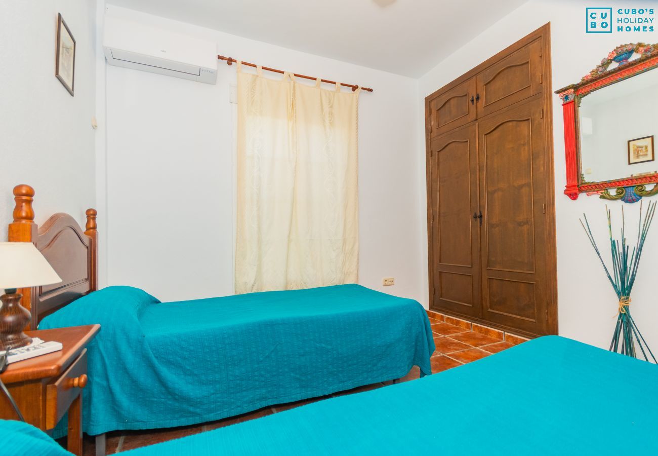 Bedroom of this house with fireplace in Coín