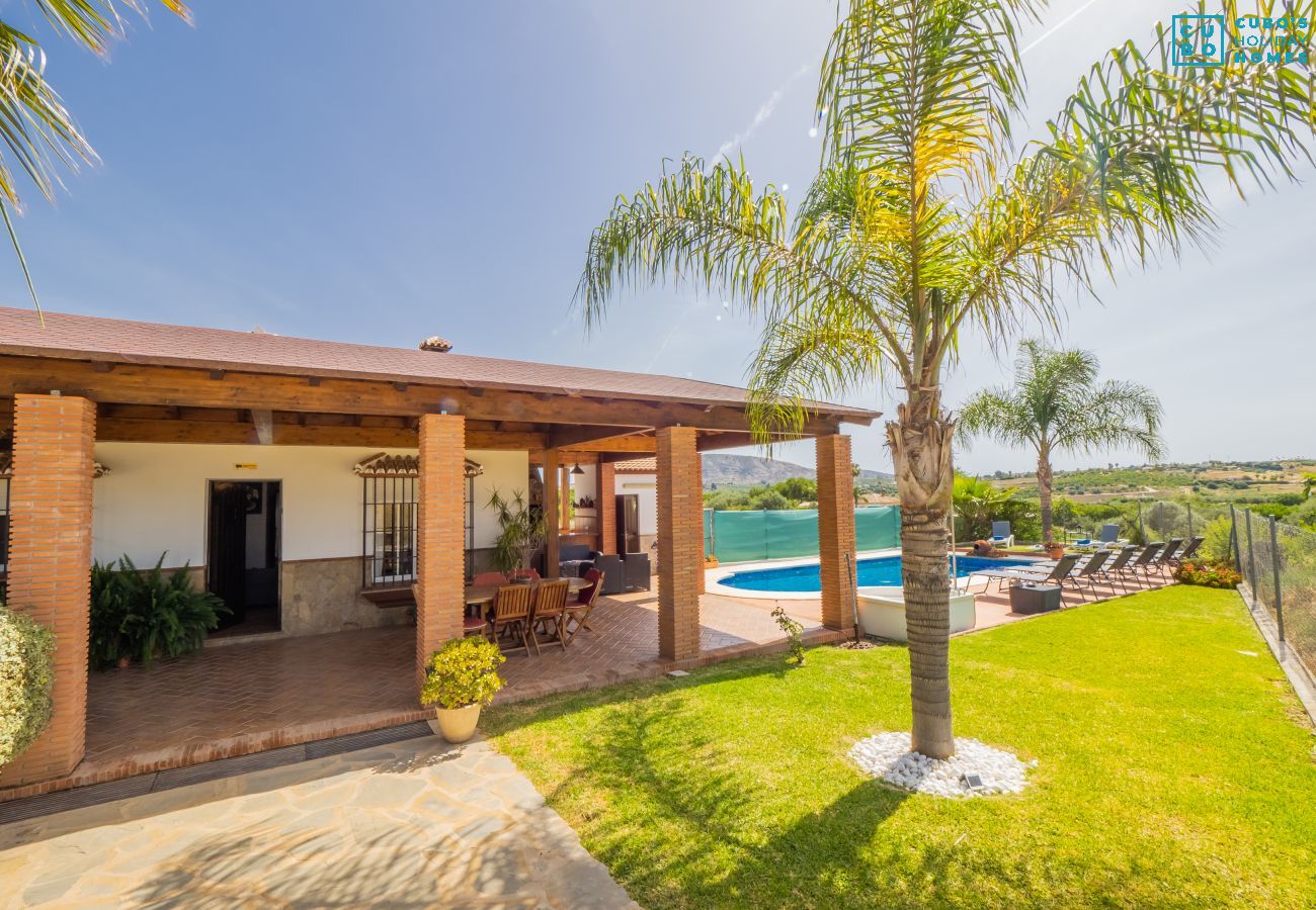 View of the garden, house and pool of the property